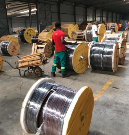 Workers handling electrical cable reels